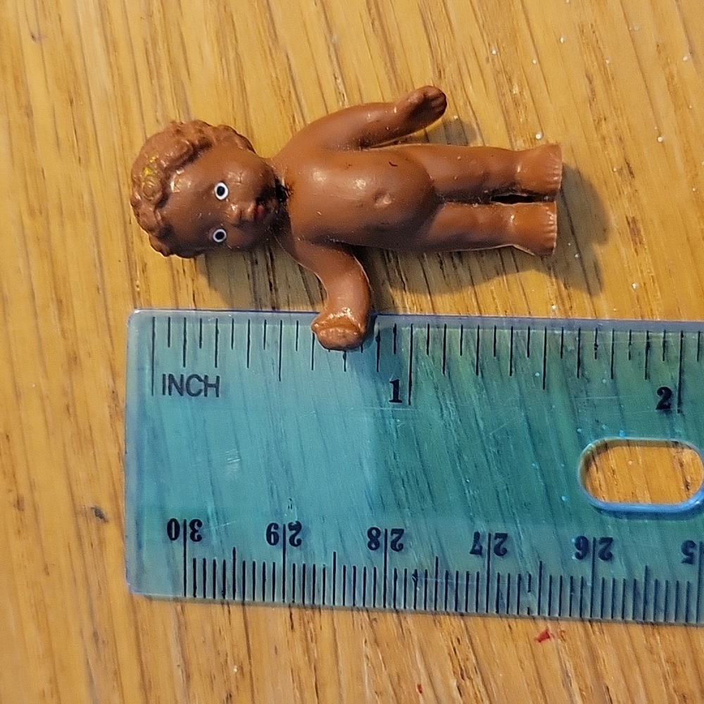 Miniature brown rubber collectible doll ( no clothes ) approx 1.5" tall